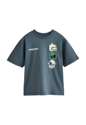 Dunkelgraues T-Shirt mit kurzen Ärmeln, Minecraft-Logo und drei pixeligen Charakterkopf-Designs, eines mit Flammen und einem "Game Over" Textblock.