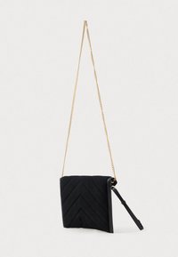 Borsa a tracolla nera trapuntata con motivo a zigzag. Presenta una tracolla dorata e una cinghia laterale per il trasporto. Dettagli in pelle liscia.