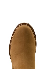 Beige Wildleder-Stiefelette mit runder Spitze, sichtbaren Nähten und einer braunen Gummisohle. Die Textur wirkt weich und glatt.