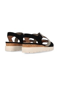 Schwarze Wildledersandalen mit Korkwedge und weißer Sohle, ausgestattet mit elastischen Riemen und einem Cut-Out-Design für Atmungsaktivität.