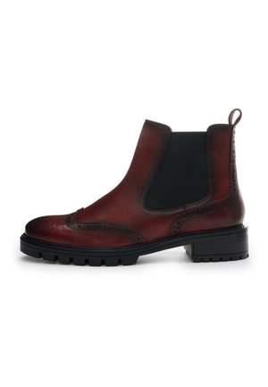 Dark red leather Chelsea boot with brogue detailing, black elastic side panel, lug sole, and pull tab at the heel.