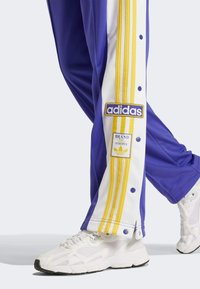 adidas Originals BREAK  - Tracksuit bottoms - energy ink   bold gold