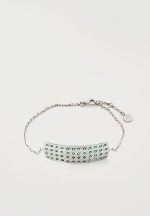 Silbernes Gliederarmband mit einer gebogenen rechteckigen Platte, die vier Reihen kleiner grüner Edelsteine zeigt, und einem Karabinerverschluss.