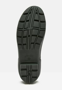 Czarna gumowa podeszwa buta z teksturowanym wzorem antypoślizgowym, rowkowymi liniami i odciskiem logo. Wykonana z trwałego materiału i o szerokim, zaokrąglonym kształcie.