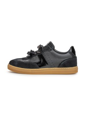 Zwarte lage sneaker met suède en glanzende panelen, geperforeerde details, zwarte veters en een lichtbruine rubberen zool.
