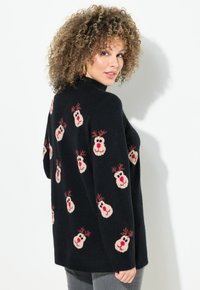 Schwarzer Pullover mit gestrickten Rentiermotiven und roten Nasen und Geweihen. Bequeme Textur mit gerippten Bündchen und Saum, lockere Passform.