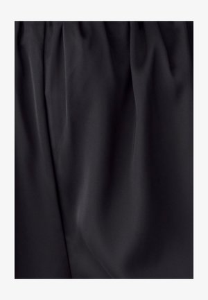 Black fabric with a smooth texture, featuring soft pleats and a gathered waistband, emphasizing a flowing design.