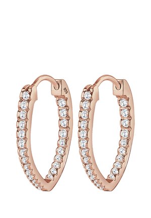 Boucles d'oreilles créoles en or rose ornées d'une rangée de pierres en zircon cubique transparent le long du bord extérieur, avec une finition lisse et polie.