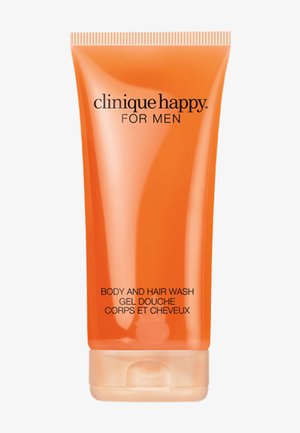 Oranje tube Clinique Happy for Men lichaams- en haarwas met flip-top dop, tekst in het Engels en Frans op de voorkant, rechtopstaand op een witte achtergrond.