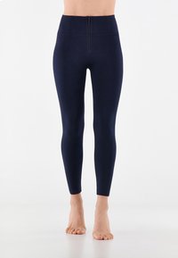 Leggings blu navy a vita alta realizzati in tessuto elasticizzato, dotati di una zip frontale e di un design fluido e aderente fino alle caviglie.