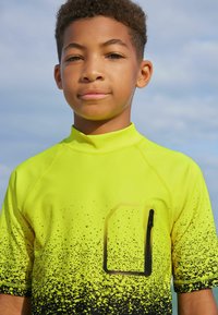 Next SHORT SLEEVE SUNSAFE  - Surfshirt - yellow black