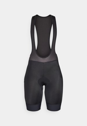 Melnas velosipēda šortus ar gludu, elastīgu audumu, ar acs aizmuguri, pastiprinātām šuvēm un polsterētu sēdekļa daļu komfortam.