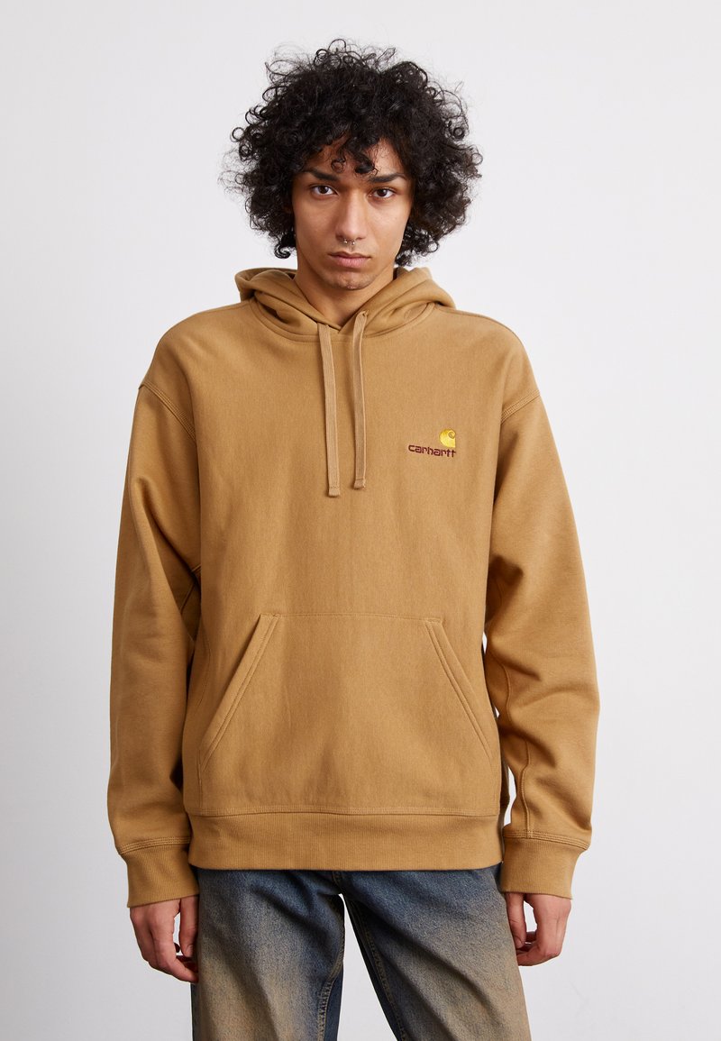 Brown hooded sweatshirt with a front pocket, ribbed cuffs, and a small logo on the left chest. Material appears soft and fleece-like.
