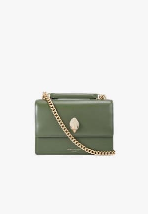 Green leather handbag with a structured design, gold chain strap, and a decorative shell-shaped accent on the front.