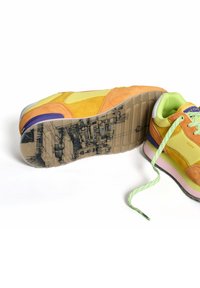 Multicolored sneaker featuring orange suede, yellow panels, and a green mesh tongue. Rubber sole with graphic detail and green laces.