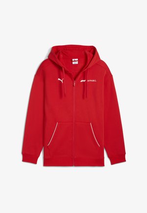 Red hooded sweatshirt with zip front, kangaroo pockets, white logo detailing, and a soft cotton blend material.