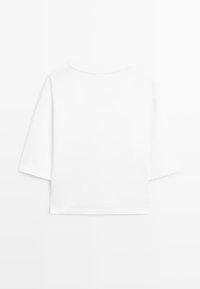 Einfaches weißes, kurzes Crop-T-Shirt mit kurzen Ärmeln und rundem Ausschnitt, von hinten auf weißem Hintergrund gezeigt.