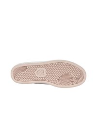 Kannan pohja, jossa on beige kumin materiaali, ja herringbone-kuvio, joka tarjoaa pitoa, sekä logo keskellä. Litteä ja pyöristetty muoto.