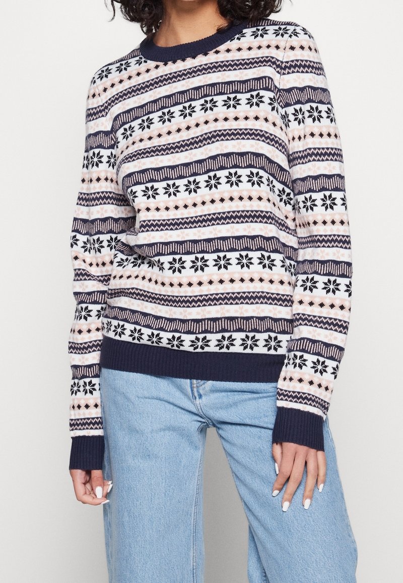 Suéter de punto azul marino con patrones geométricos y copos de nieve multicolores, cuello redondo, puños y dobladillo acanalados, con un ajuste relajado.