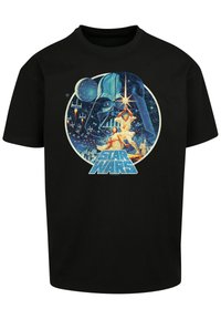 Black cotton T-shirt featuring a colorful graphic of Darth Vader and characters from Star Wars within a circular design.