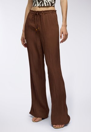 Pantaloni marroni a gamba larga realizzati in tessuto strutturato, con vita elastica e cordoncino, impreziositi da perline di legno.
