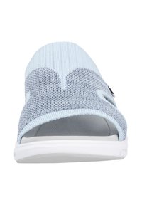 Light blue and gray knitted slip-on sandal with elastic upper, open toe, and white rubber sole. Textured knit pattern with smooth accents.
