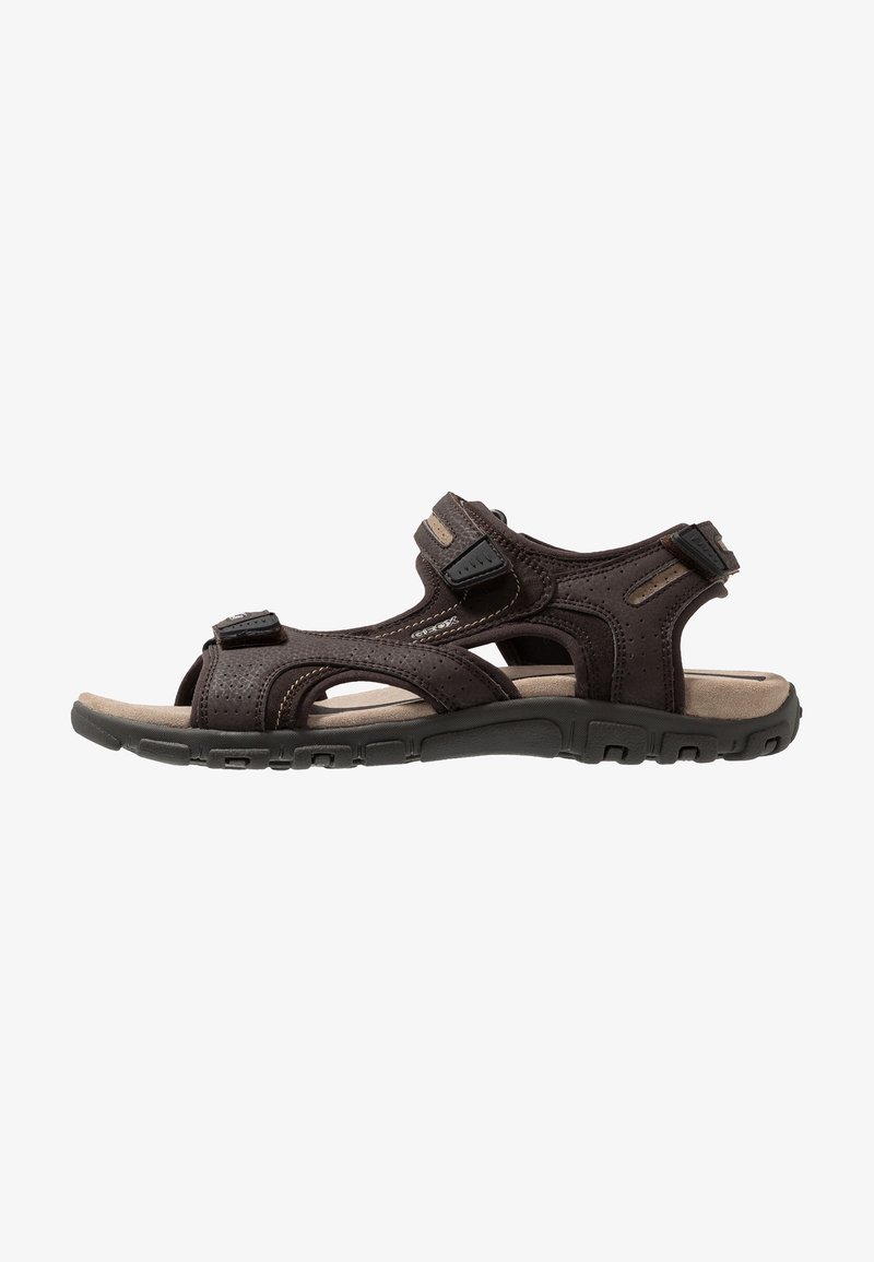 Sandalha castanha com várias tiras ajustáveis, parte superior perfurada, palmilha acolchoada e sola de borracha texturizada para aderência e conforto.