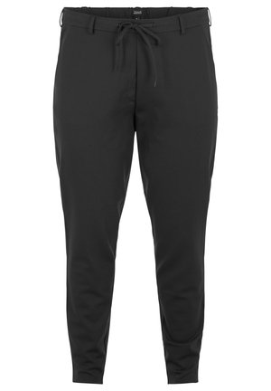 Pantalons de jogging noirs, légers, en matériau doux. Dotés d'une taille à cordon de serrage, de jambes fuselées et sans motifs ni éléments matériels proéminents.