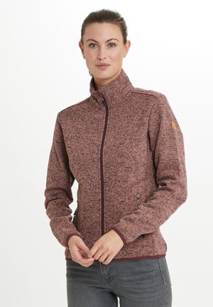 Veste zippée bordeaux avec col montant, poches latérales et poignets contrastés. Texture lisse avec des détails de motif subtils.