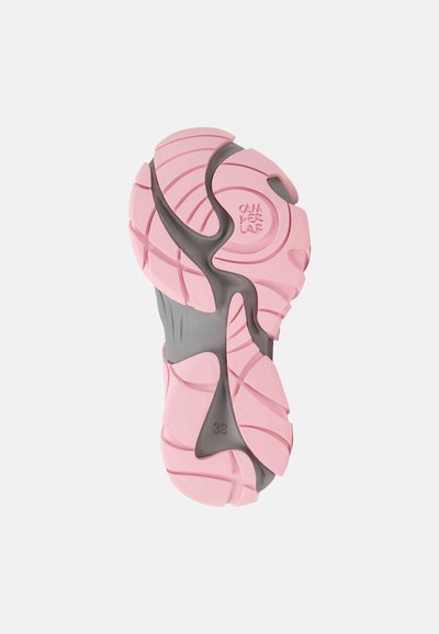 Shoe outsole featuring pink rubber with curved grooves and gray accents. Includes a size marking of 38. Textured for traction.