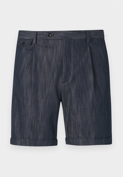 Tumedad sinised lühikesed püksid, mis on valmistatud tekstuuritud kangast. Pükstel on volditud äär, ees pleated detailid ja ühe nööbiga klõps sulguri piirkonnas.