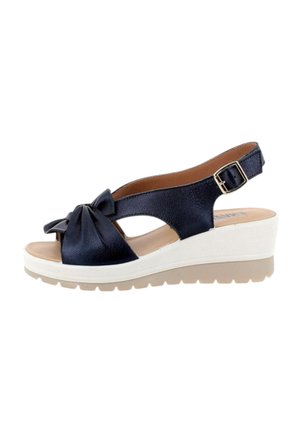 Sandalo zeppa blu navy con suola bianca, punta aperta, cinturino frontale annodato e cinturino alla caviglia regolabile con fibbia.