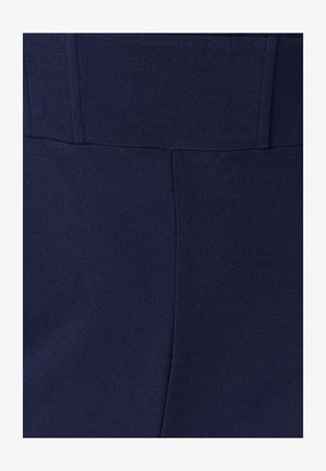 Tissu bleu marine à la texture lisse, avec une taille droite et des coutures ajustées, mettant en valeur un design structuré.