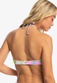 Bikini top with pink base, adjustable halter tie, floral pattern in green and blue, clasp closure at the back for secure fit.