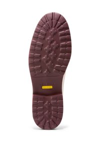 Rubber shoe sole in burgundy with a textured tread pattern. Features branding and model information in yellow on a smooth section.