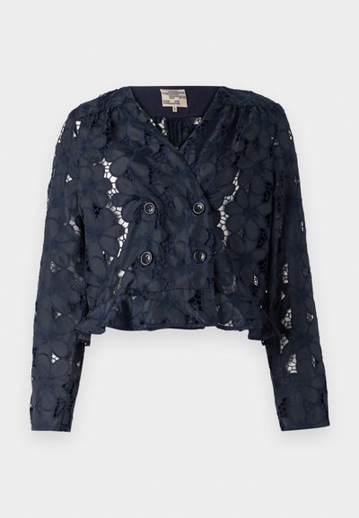 Navy blue cropped jacket made of lace with floral patterns, featuring a double-breasted front and two buttons. Textured, semi-sheer fabric.