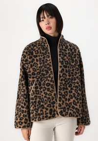 Leopardmønstret jakke i blødt, tekstureret stof med lysebrunt kantbånd, som har trykknapper og to forlommer. Løs pasform med brede ærmer.