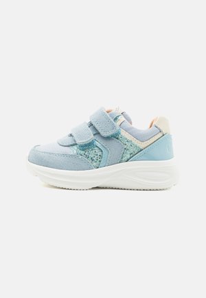 Light blue sneakers with suede and glitter accents, featuring two Velcro straps and a textured white rubber sole.