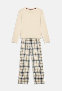 Cream long-sleeve top with small logo paired with beige, black, and white plaid elastic-waist pants laid flat on white background.