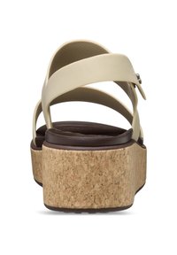 Sandalias de plataforma beige con tiras entrelazadas, base texturizada de corcho y una plantilla marrón suave. Presenta un pequeño detalle metálico.
