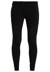 Svart leggings med en slät textur, åtsittande design och sydda paneldetaljer. Tillverkade av stretchigt material för komfort och rörlighet.