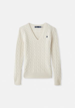 V-neck cable-knit sweater in cream, featuring ribbed cuffs and hem, with a small embroidered logo on the left chest. Made of soft knit material.