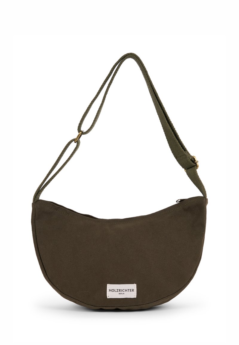 Olive green canvas handbag, crescent shape, adjustable strap, zipper closure, branded label in white and black at the front.