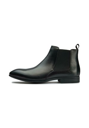 Black leather Chelsea boot with a smooth finish, elastic side panels, and a loop pull tab; tapered toe and low rubber heel.