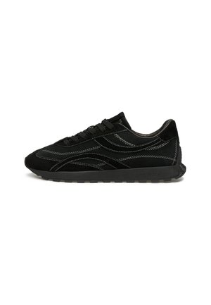 Sneakers in suede nera con cuciture bianche a contrasto, punta arrotondata, suola piatta in gomma e design classico con lacci. Profilo minimalista.