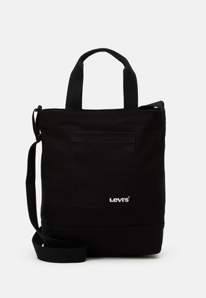 Black Levi's tote bag with front pocket, dual handles, and adjustable shoulder strap on plain light background.