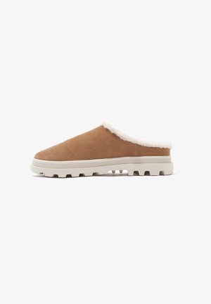 Suede slip-on shoes in light brown with a fluffy white lining and a textured beige rubber sole featuring raised tread for traction.
