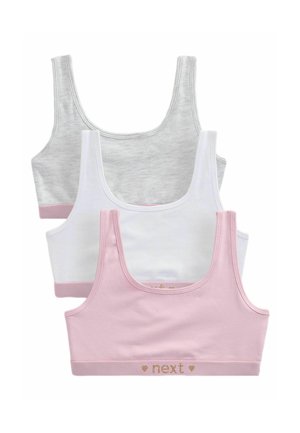 Drie katoen bralettes in grijs, wit en roze. Elke met brede bandjes en een contrasterende tailleband met "next" in een gouden tint erop gedrukt.