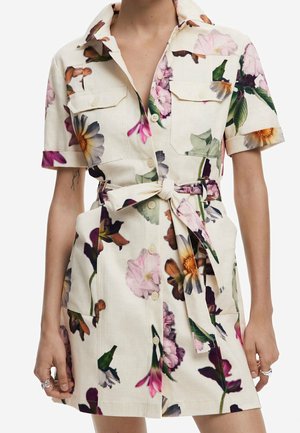 Short floral button-up dress with short sleeves, two chest pockets, and a self-tie belt at the waist.