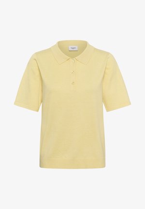 Lichtgele polo met korte mouwen, drie knopen en een geribde zoom, kraag en mouwen, met een label "Saint" aan de binnenkant van de kraag.